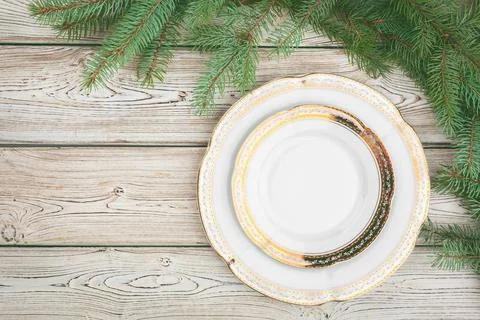 Wooden table with pine tree branches and holiday table setting Stock Photos