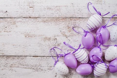 Wooden table with purple easter eggs Stock Photos