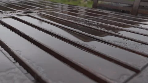 Wooden table in the rain, slow motion video Stock Footage 306148344