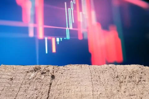 Wooden table with red chart in background. Crisis concept. Stock Photos