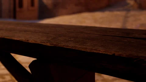 Wooden table with rough texture near stone pathway and building in evening Stock Footage 343546077