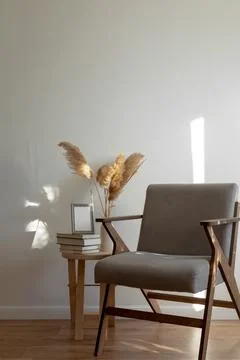 Wooden table with stack of books and vase with pampas grass, mock-up gray fra Stock Photos