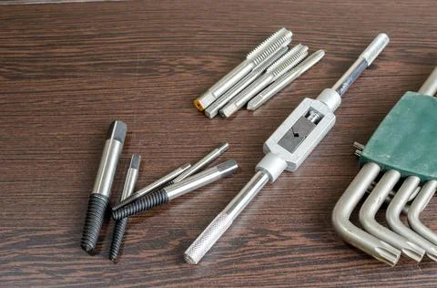 On a wooden table a tool for cutting a thread close-up Stock Photos