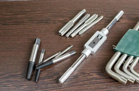 On a wooden table a tool for cutting a thread close-up Stock Photos