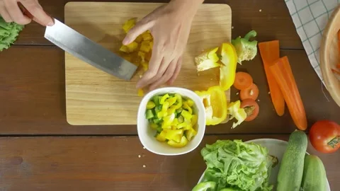 A wooden table topped with different types of food 库存影片 157868813