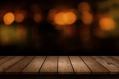 Wooden table with a view of blurred beverages bar backdrop. Blur cafe and res Stock Photos