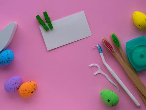 Wooden toothbrushes with Easter decorations on pink background Stock Photos