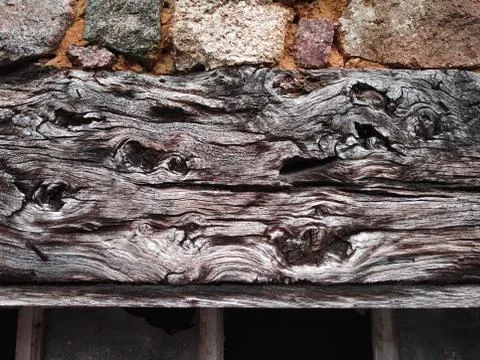 Wooden top beam with burls of an old window in France Stock Photos