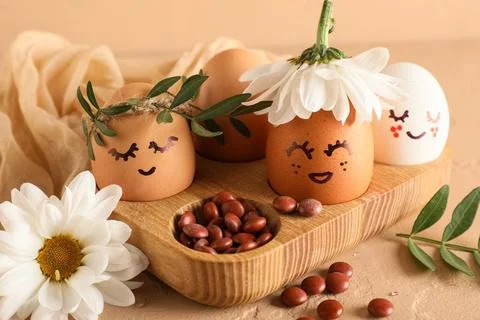 Wooden tray of creative Easter eggs with fabric, flowers and leaves on grunge Stock Photos
