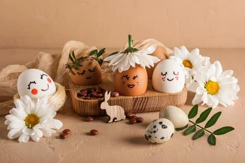 Wooden tray of creative Easter eggs with fabric, flowers and leaves on grunge Stock Photos