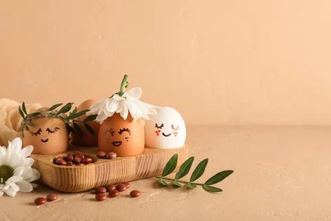 Wooden tray of creative Easter eggs with fabric, flowers and leaves on grunge Stock Photos