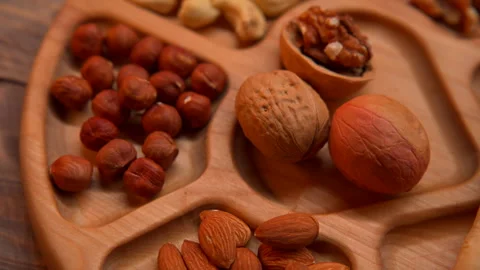 Wooden Tray Filled With Nuts and Nutshells Stock Footage 273710141