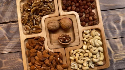 Wooden Tray Filled With Nuts on Table Stock Footage 273710026