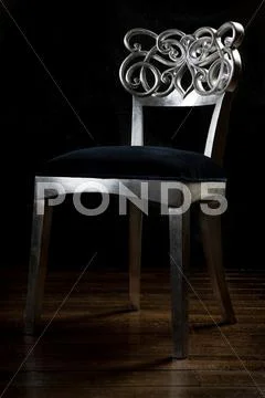 Wooden vintage chair with carved back. painted with silver color. Stock Photos