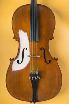 Wooden violin with string yellow background Stock Photos