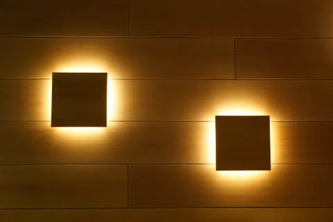 Wooden wall as a background with a dark backlighted squares Stock Photos