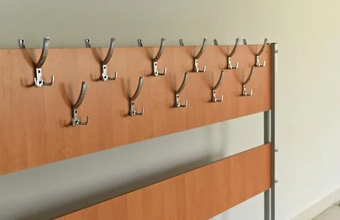 Wooden wall coat rack with multiple metal hooks, 스톡 사진