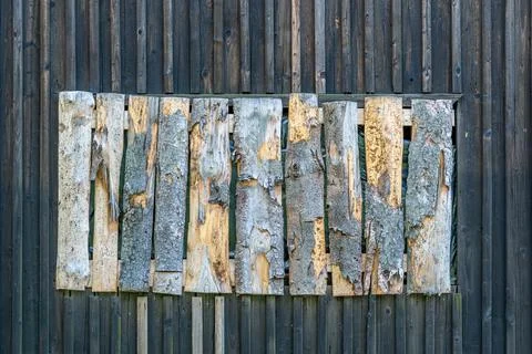 Wooden wall oriented vertically with a hammered window Stock Photos