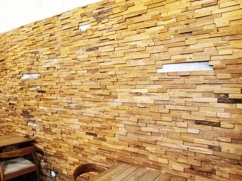 Wooden wall paneling with textural pattern and warm tones creating a rustic.. Stock Photos