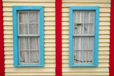 Wooden wall with two windows Stock Photos