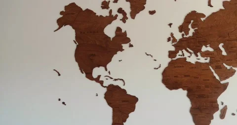Wooden world map full view pan out, elegant vintage decor, room with white wall Stock Footage 230489957
