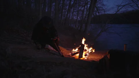Woodland trees fire at dusk with axe work near the riverbank Stock Footage 320008388