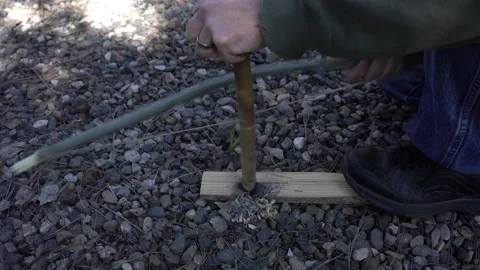 A woodsman starting a fire with a primitive bowdrill Video stock 242729633