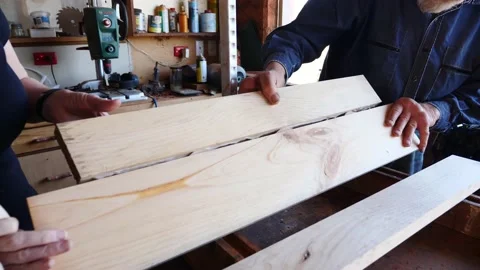 Woodwork biscuit joining glue up timber older gentleman training lady assist Stock Footage 231789712