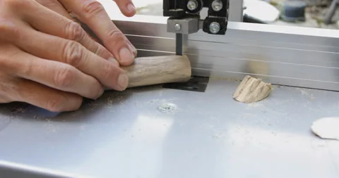 Woodwork craft, cutting driftwood using bandsaw, close-up Stock Footage 138987693