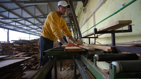 Woodwork industry worker cutting planks with circular saw Stock Footage 46915526