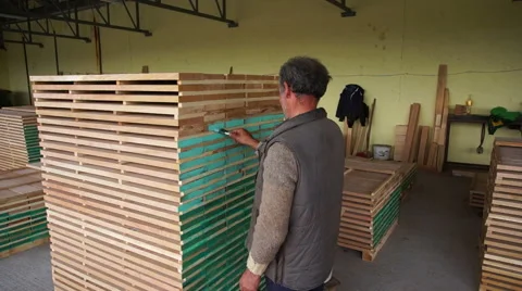 Woodwork industry worker marking finished planks Stock Footage 46901270