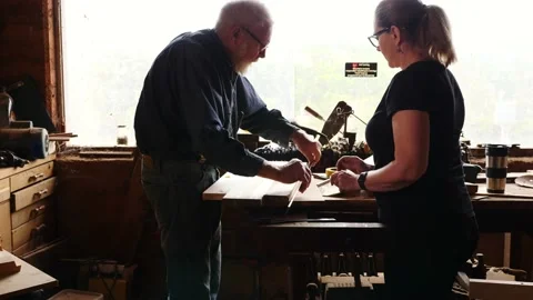 Woodwork marking measuring timber older gentleman and lady assistant backlit Stock Footage 231891622
