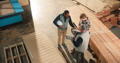 Woodwork, team and talking with tablet in warehouse, timber inventory or Stock Footage 341310620