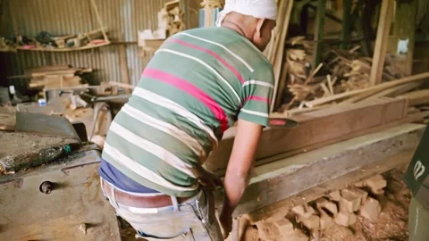 Woodworker adjusts plank on workbench with care Stock Footage 297598472