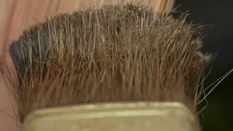 The woodworker applies a protective layer of linseed oil Stock Footage 277873746