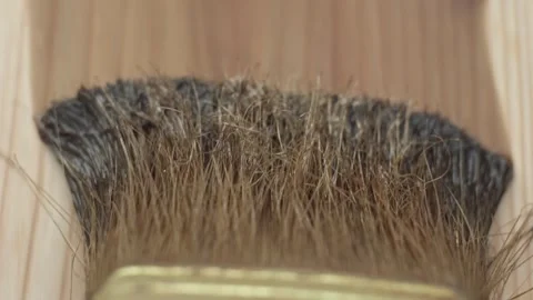 The woodworker applies a protective layer of linseed oil Stock Footage 277873748
