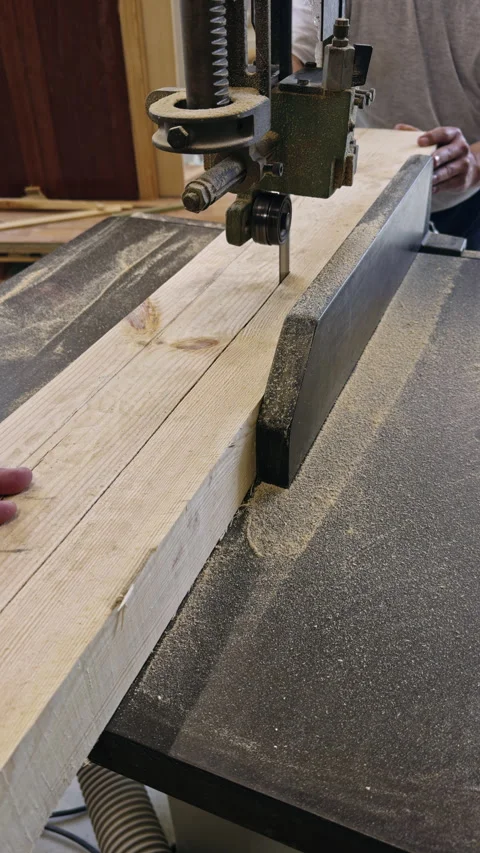 Woodworker Cutting Lumber on Bandsaw in Workshop Видео 337550229
