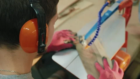 Woodworker cutting pattern out wood on jumping jigsaw machine Stock Footage 144266584