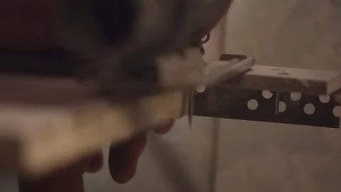 Woodworker cutting a piece of wood using a jigsaw Stock Footage 84824190