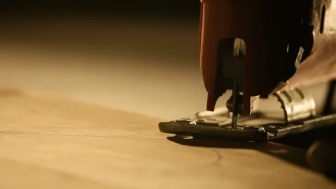 Woodworker cutting a piece of wood using a jigsaw Stock Footage 88325111