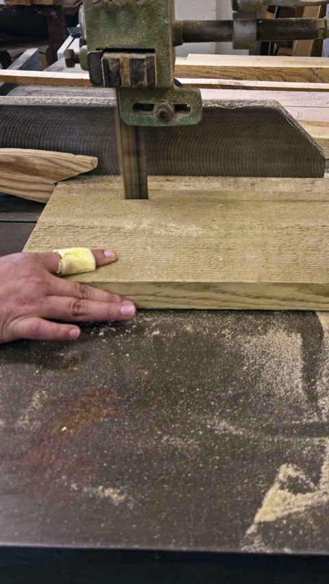 Woodworker cutting plank on bandsaw Stock-Footage 337548991