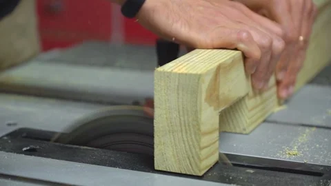 Woodworker finishing a lap joint on a table saw Stock Footage 260089032