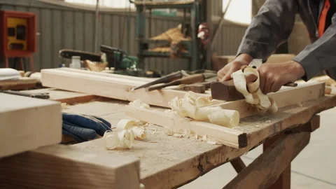 A woodworker is hard at work using a plane 動画素材 274177875