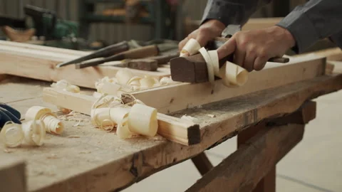 A woodworker is hard at work using a plane Stock Footage 274177937