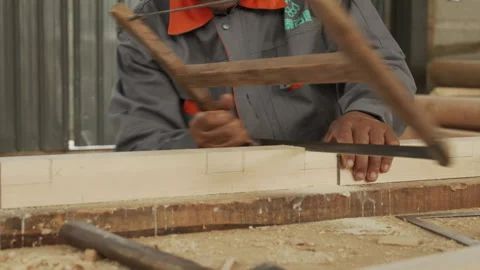 A woodworker is hard at work using a saw 動画素材 274177892