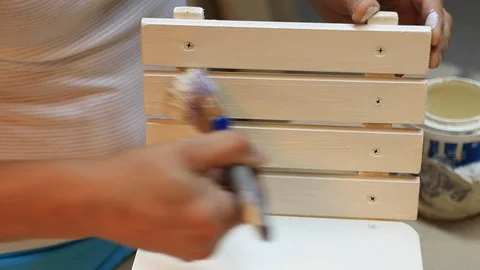 Woodworker Man Work Use Paint Brush Paint Child Wood Chair in Carpentry Workshop Stock Footage 110090810