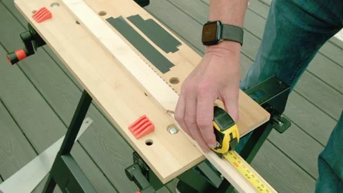 Woodworker measures lumber on a workbench Stock Footage 342053371