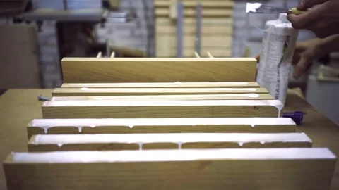 Woodworker puts glue on the prepared boards so that they can be glued together Stock Footage 102785201