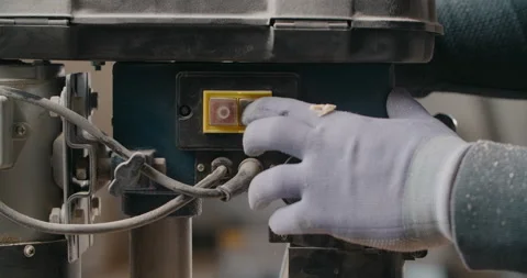 Woodworker turns on the drilling machine in slow motion, carpentry at workshop Stock Footage 149299500