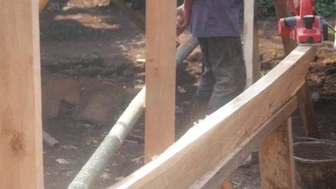 A woodworker uses an electric planer to smooth the surface of a wooden Stock Footage 333345295